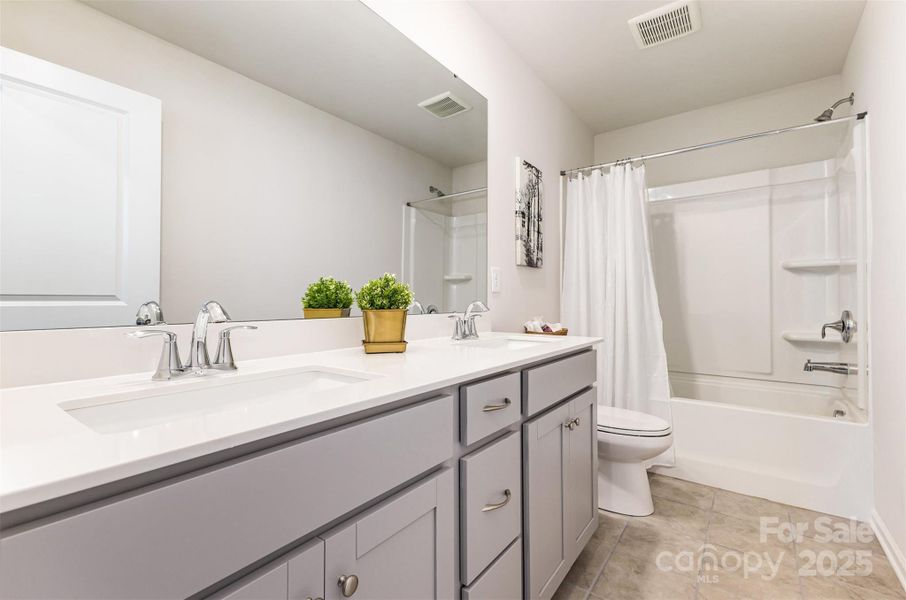 Secondary full bathroom with double vanity