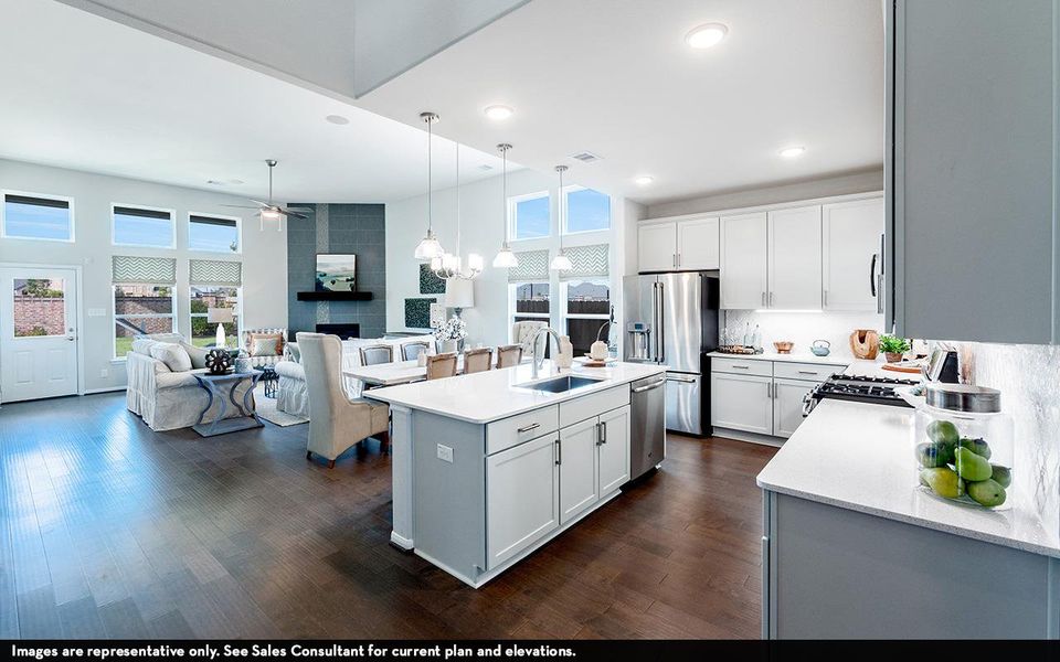 Kitchen with stainless steel appliances, a sink, ceiling fan, light countertops, and recessed lighting Kitchen with stainless steel appliances, a sink, ceiling fan, light countertops, and recessed lighting