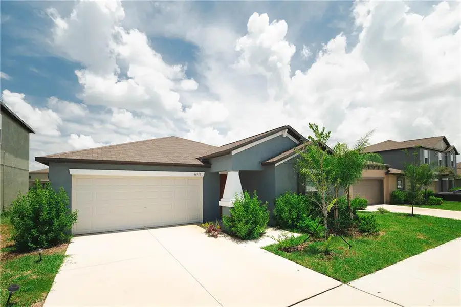 Front exterior of a new home in Triple Creek: The Estates II, Riverview, FL, highlighting curb appeal (Image 1). Front exterior of a new home in Triple Creek: The Estates II, Riverview, FL, highlighting curb appeal (Image 1).