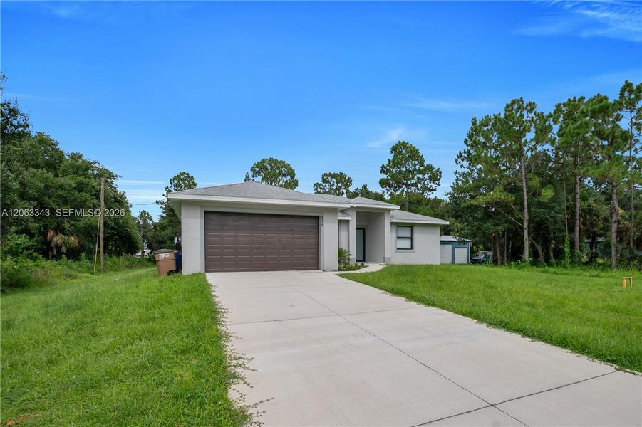 Front exterior of a new home in , Lehigh Acres, FL, highlighting curb appeal (Image 20). Front exterior of a new home in , Lehigh Acres, FL, highlighting curb appeal (Image 20).