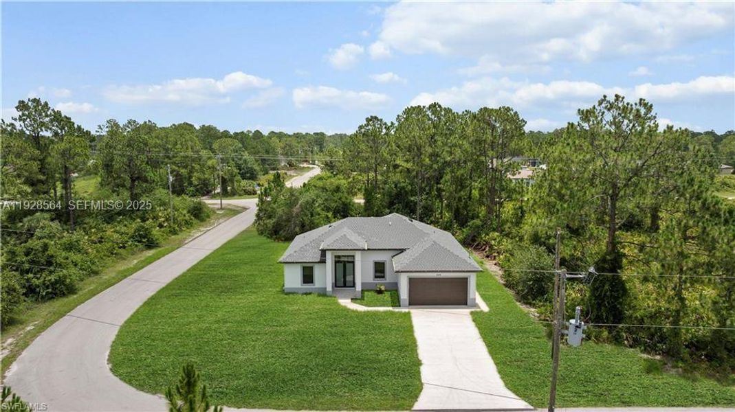 Front exterior of a new home in , Lehigh Acres, FL, highlighting curb appeal (Image 20).