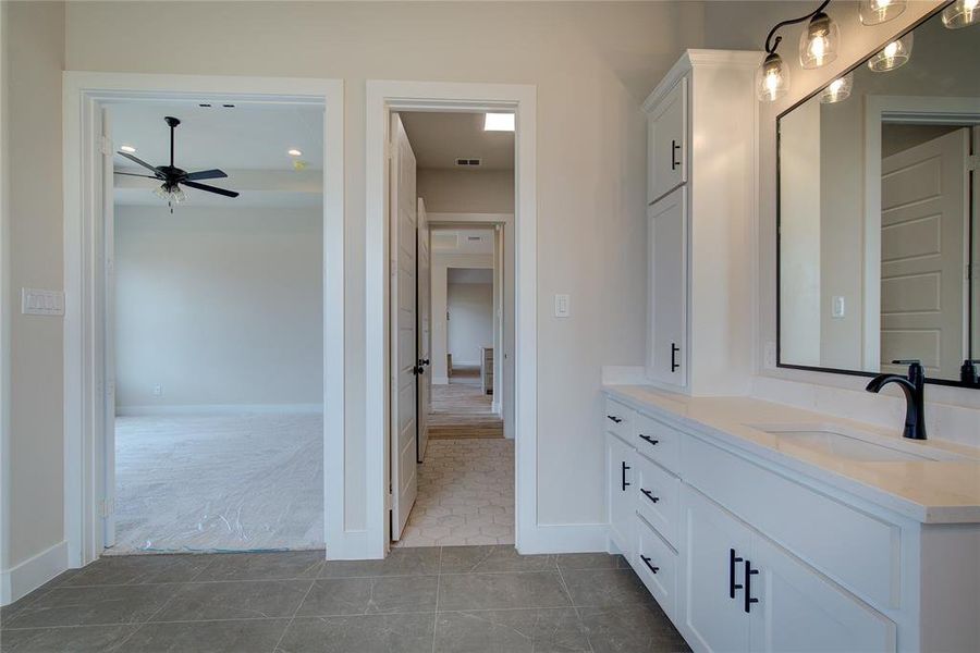 Bathroom with tile flooring, vanity, and ceiling fan