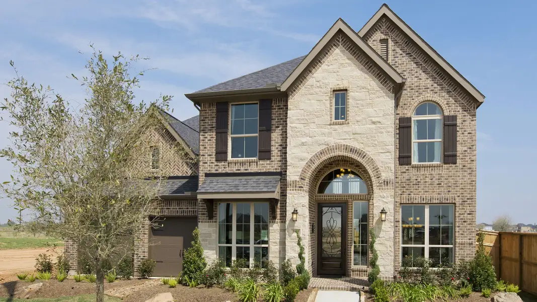 Front exterior of a new home in Meridiana, Manvel, TX, highlighting curb appeal (Image 17).