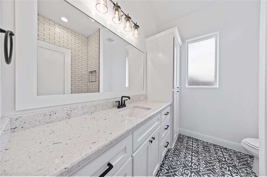 Bathroom featuring vanity and toilet