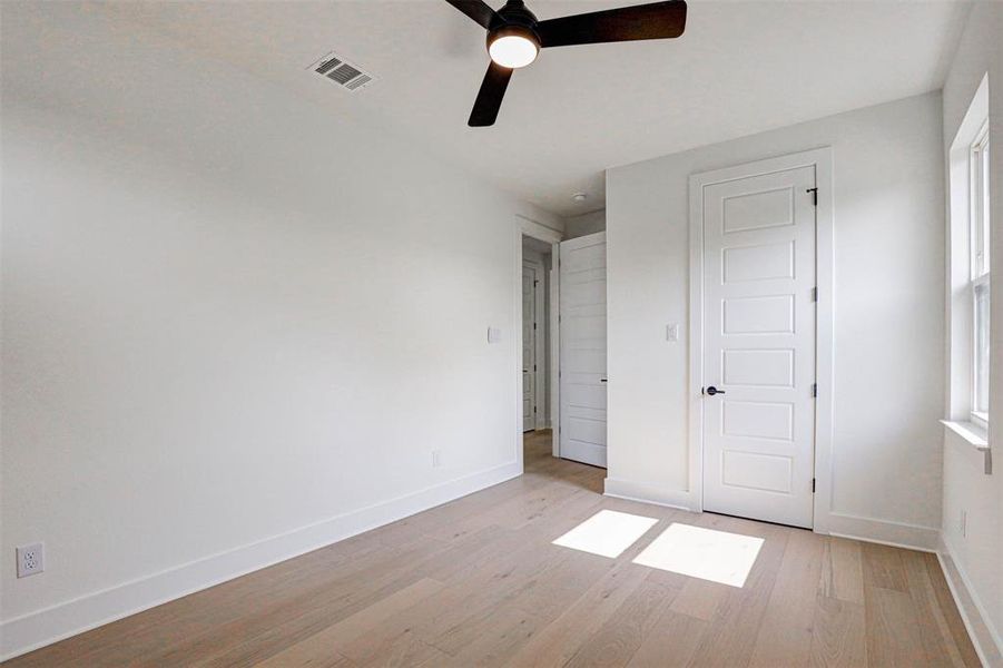 Unfurnished bedroom with light hardwood / wood-style floors, a closet, and ceiling fan