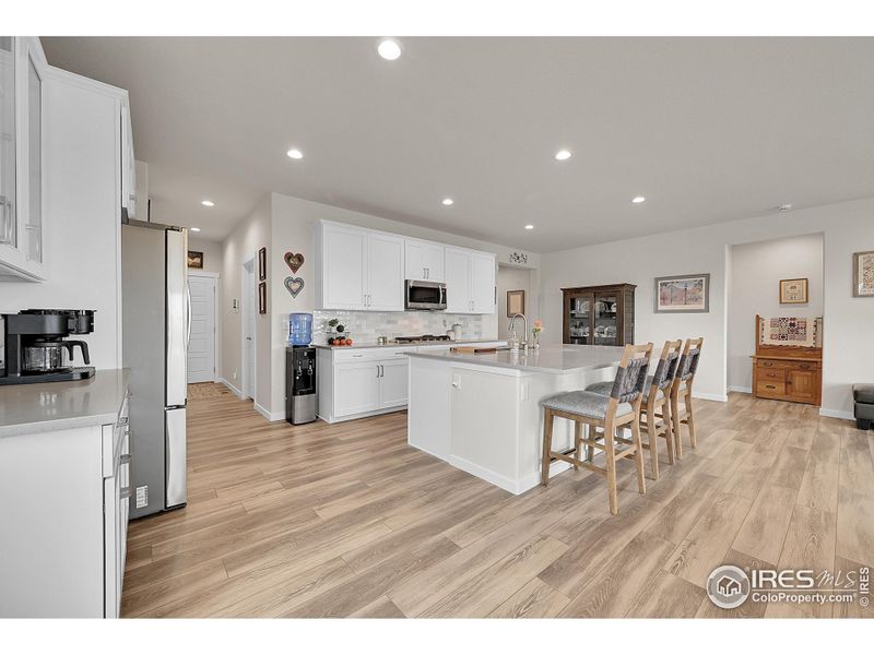 Kitchen with upgraded cabinet, quartz counters, new backsplash, gas range and stainless steel appliances