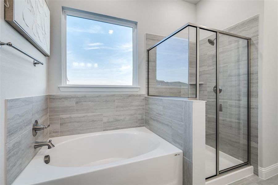 Bathroom featuring shower with separate bathtub