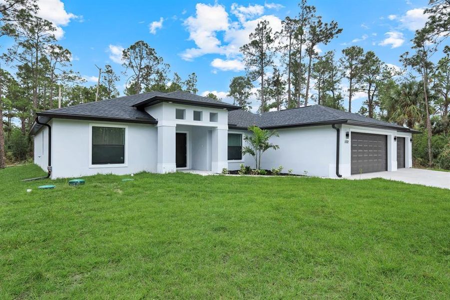 Front exterior of a new home in , Lehigh Acres, FL, highlighting curb appeal (Image 19).