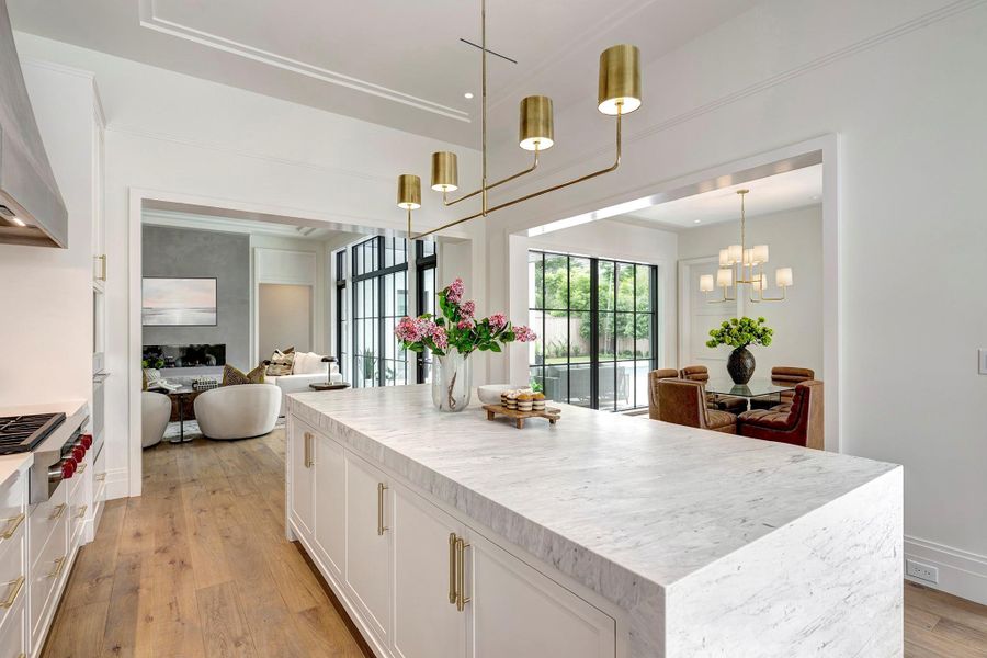 Designed for both function and flow, the chef’s kitchen offers sweeping views of the living room, covered patio, and dining room.