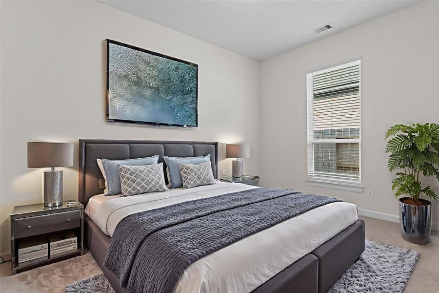 Virtually Staged – Bedroom designed for comfort, featuring tall windows, plush carpet, and abundant natural light.