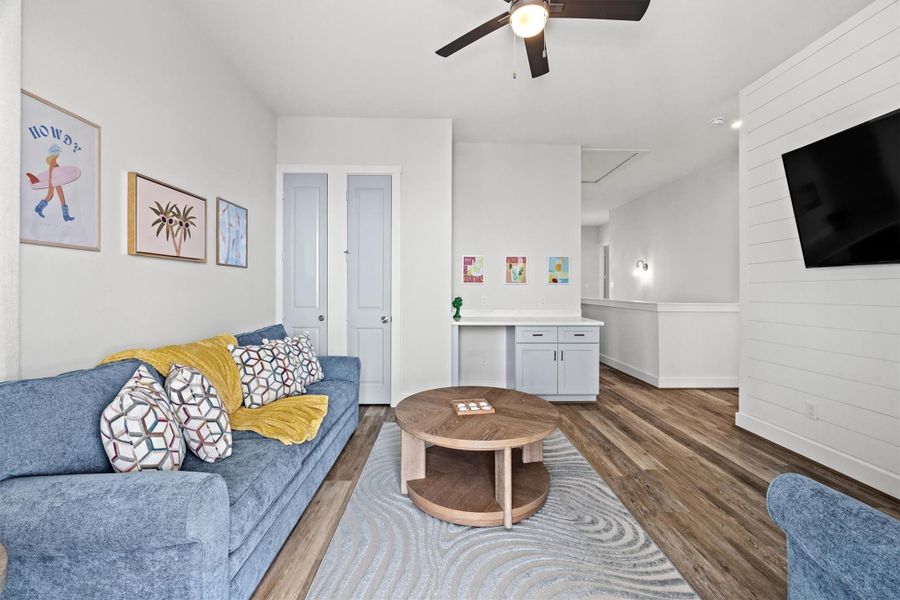 Another view of the game room reveals a versatile workstation with a quartz top, offering plenty of storage space. It’s perfect for a productive corner or adding a second beverage refrigerator for ultimate convenience.