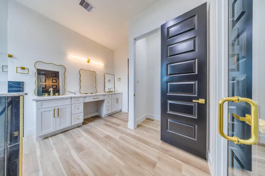 Three gorgeous mirrors enhance the bathroom’s elegance, reflecting light and adding a stylish, luxurious touch to the space. Three gorgeous mirrors enhance the bathroom’s elegance, reflecting light and adding a stylish, luxurious touch to the space.