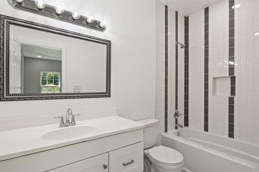 Bathroom with vanity and tub / shower combination