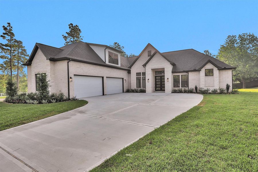 Spacious driveway leads to a 4-car garage, offering ample room for vehicles, storage, or workshop needs. Spacious driveway leads to a 4-car garage, offering ample room for vehicles, storage, or workshop needs.