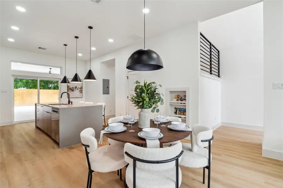 Thoughtful details like a built-in display nook and oversized sliding doors enhance this bright, open layout—balancing modern style with everyday function. Thoughtful details like a built-in display nook and oversized sliding doors enhance this bright, open layout—balancing modern style with everyday function.