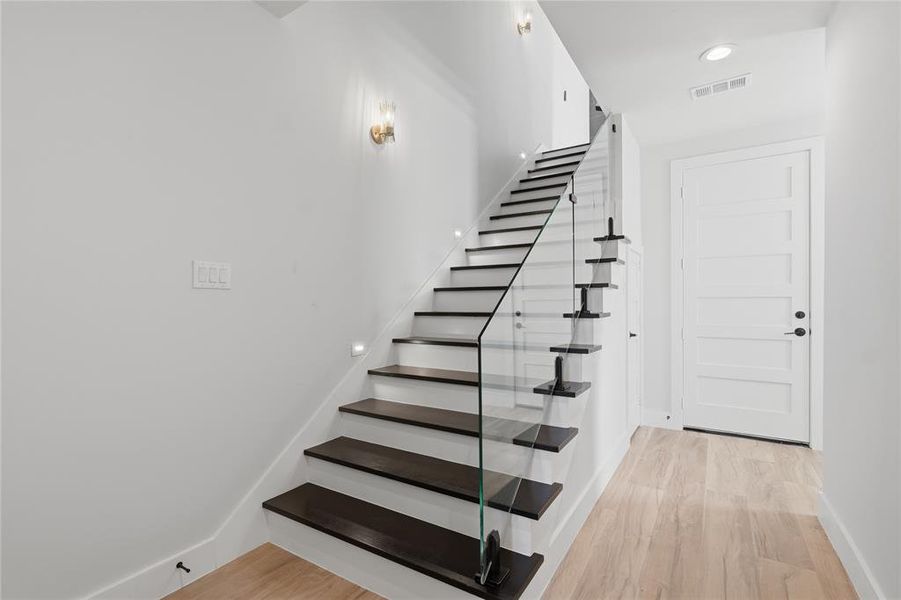 Stairway with wood finished floors and recessed lighting Stairway with wood finished floors and recessed lighting