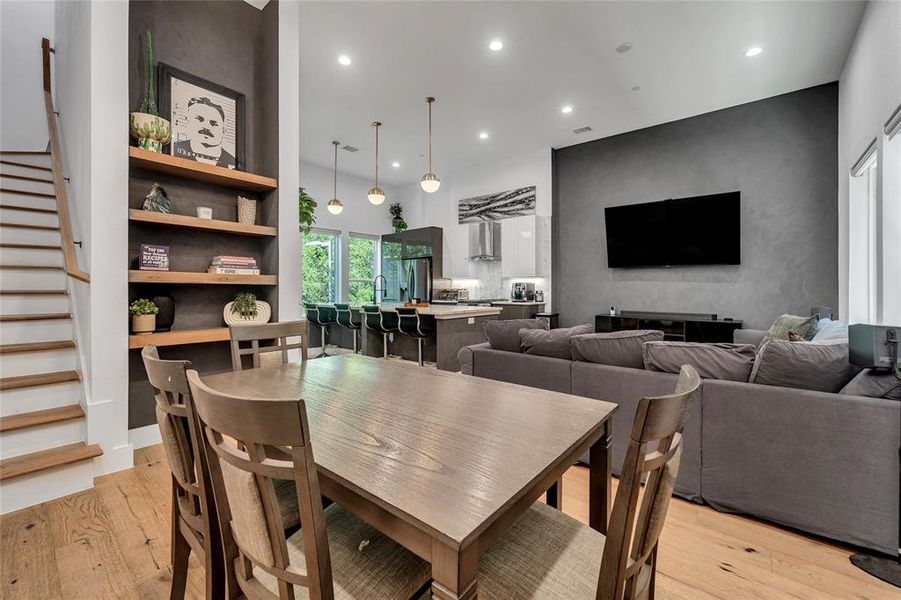 Dining area featuring light wood-style floors, recessed lighting, and stairs Dining area featuring light wood-style floors, recessed lighting, and stairs