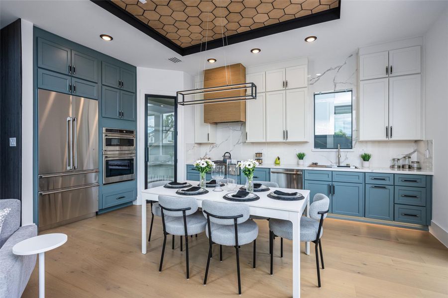 Enjoy two-tone custom cabinetry in designer hues, luxurious porcelain countertops, and full-height backsplash. A glass-framed pantry with interior countertop and GE Café appliances complete this dream kitchen Enjoy two-tone custom cabinetry in designer hues, luxurious porcelain countertops, and full-height backsplash. A glass-framed pantry with interior countertop and GE Café appliances complete this dream kitchen