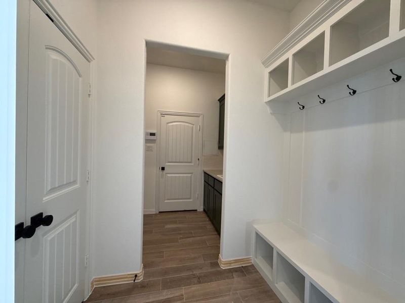 Mudroom with wood tiled floors and baseboards