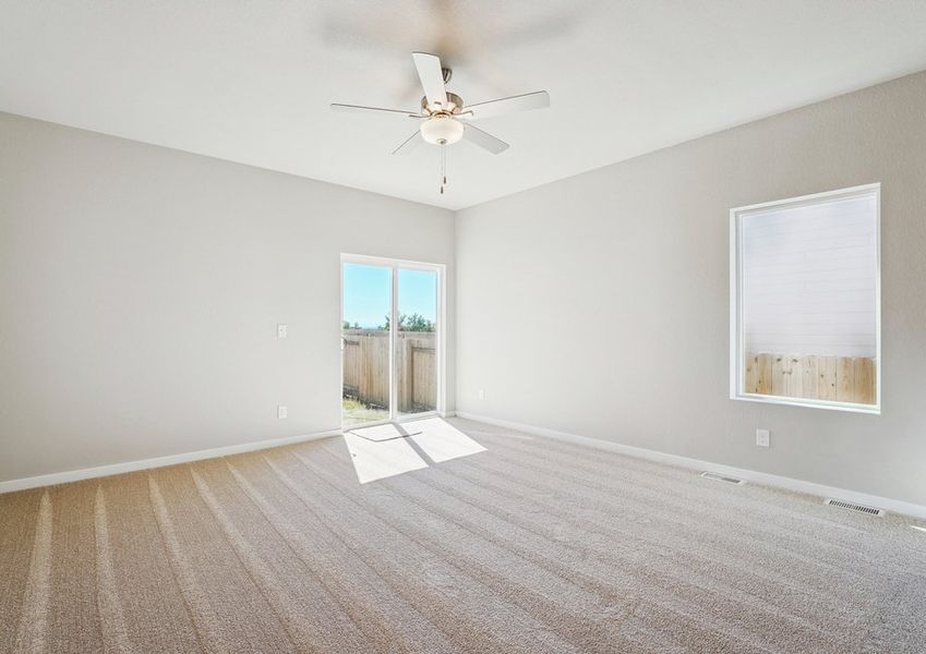 The family room is spacious with a ceiling fan.