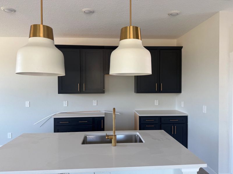 Kitchen features a large kitchen island and designer upgrades from the AW Sapphire Collection