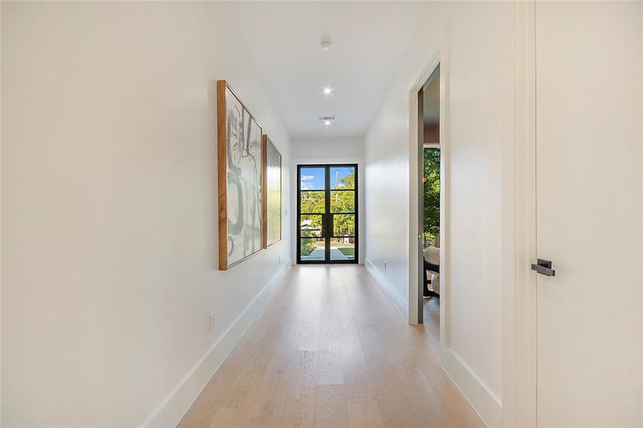 Hall featuring wood finished floors and baseboards Hall featuring wood finished floors and baseboards