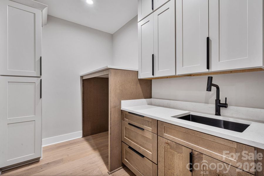 Main level laundry with sink and custom dog bowl station
