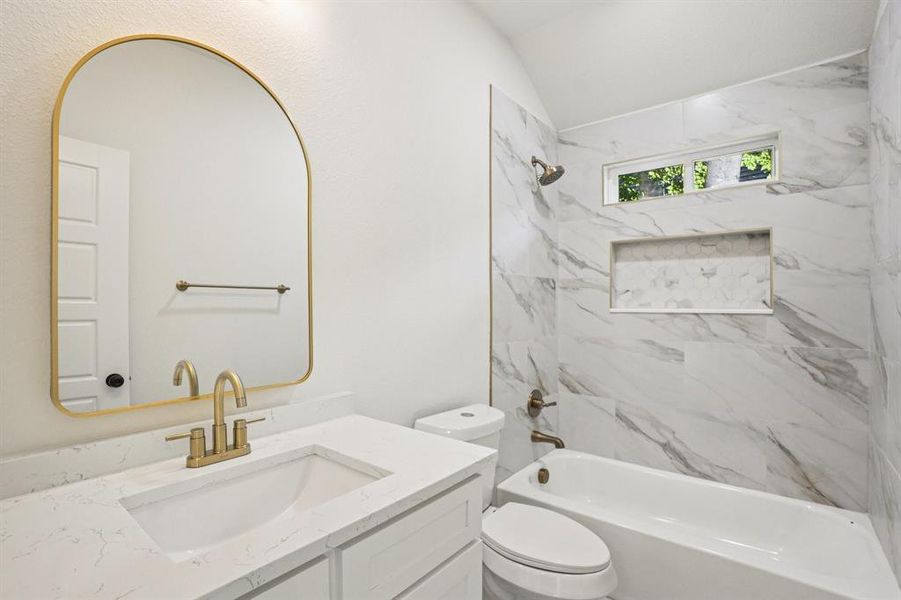 Bathroom with shower / bath combination, vanity, and lofted ceiling Bathroom with shower / bath combination, vanity, and lofted ceiling
