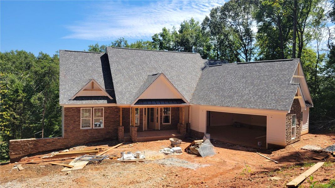 Multi-textured siding and sharp gables define the Multi-textured siding and sharp gables define the
