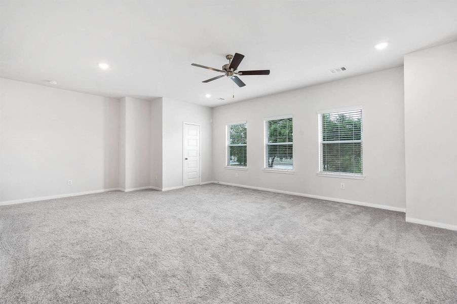 Large windows flood the upper living space with natural light, creating a bright, inviting spot to unwind. Large windows flood the upper living space with natural light, creating a bright, inviting spot to unwind.