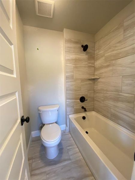 Private section of Jack & Jill bath 4 with commode & tub/shower Private section of Jack & Jill bath 4 with commode & tub/shower