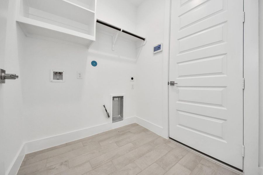 A perfect blend of functionality and comfort. Capture the essence of easy living with a first-floor laundry room, thoughtfully equipped with shelving for effortless organization. Both electric and gas connections available.