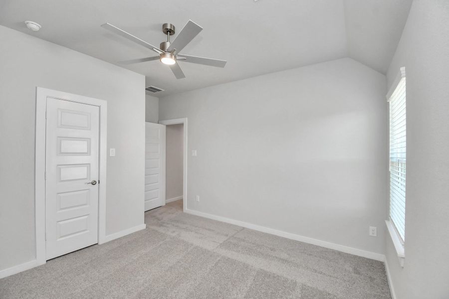Generously sized secondary bedrooms featuring spacious closets, soft and inviting carpeting underfoot, large windows allowing plenty of natural light, and the added touch of privacy blinds for your personal retreat. Sample photo of completed home with similar floor plan. Actual colors and selections may vary.