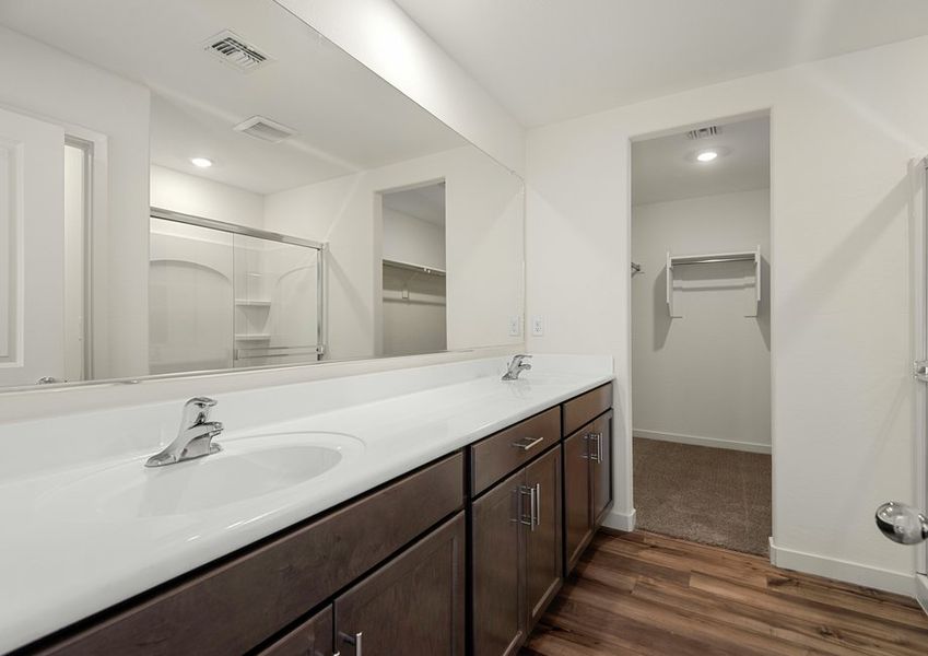 The master bathroom features spacious countertops for you to get ready.