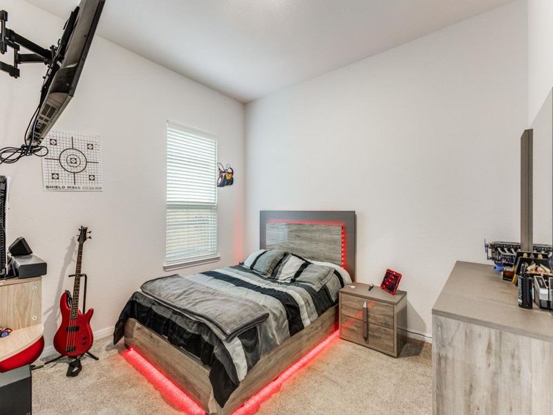 This is the first of two secondary bedrooms that are set up with their own shared flex space between them. Bonus, none of the bedrooms in the home share walls with another bedroom!