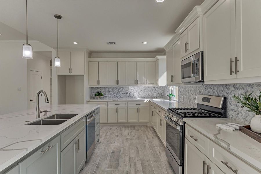 Well appointed with stunning hardware selections and a herringbone backsplash to give this kitchen contrast. Well appointed with stunning hardware selections and a herringbone backsplash to give this kitchen contrast.