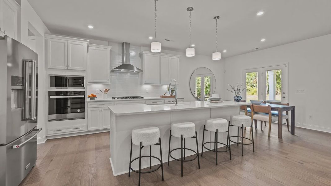 The Townsend Design gourmet kitchen with wall oven and built-in microwave at Lakeside Glen by DRB Homes in York, SC.