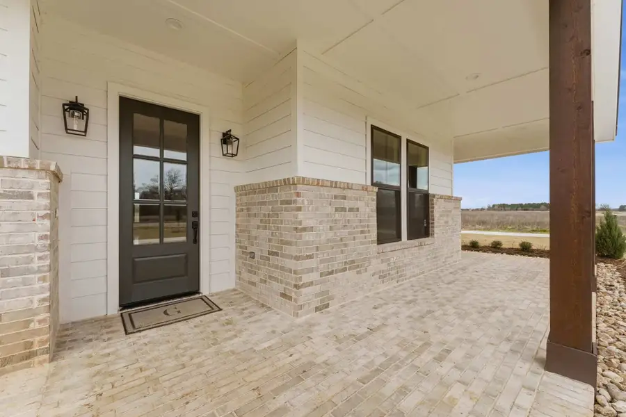 Exterior details and patio area of a home in The Manors, New Waverly (Image 3). Exterior details and patio area of a home in The Manors, New Waverly (Image 3).