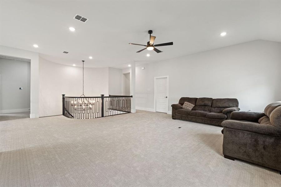 Living room with a chandelier, carpet floors, recessed lighting, and a ceiling fan