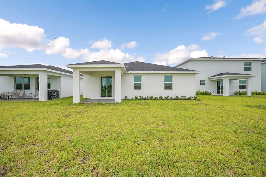 Front exterior of a new home in Seagrove: The Indies, Fort Pierce, FL, highlighting curb appeal (Image 15). Front exterior of a new home in Seagrove: The Indies, Fort Pierce, FL, highlighting curb appeal (Image 15).