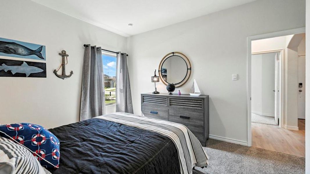 This property features a room with light-colored walls and grey carpeting