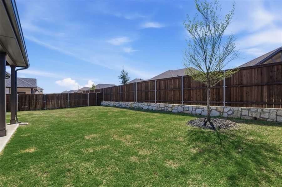 Exterior details and patio area of a home in Whitewing Trails, Princeton (Image 27).