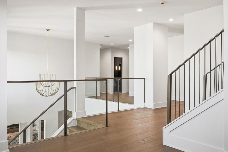 From this perspective on the second floor landing, the upper level showcases four large en-suite bedrooms alongside a spacious game room. From this perspective on the second floor landing, the upper level showcases four large en-suite bedrooms alongside a spacious game room.