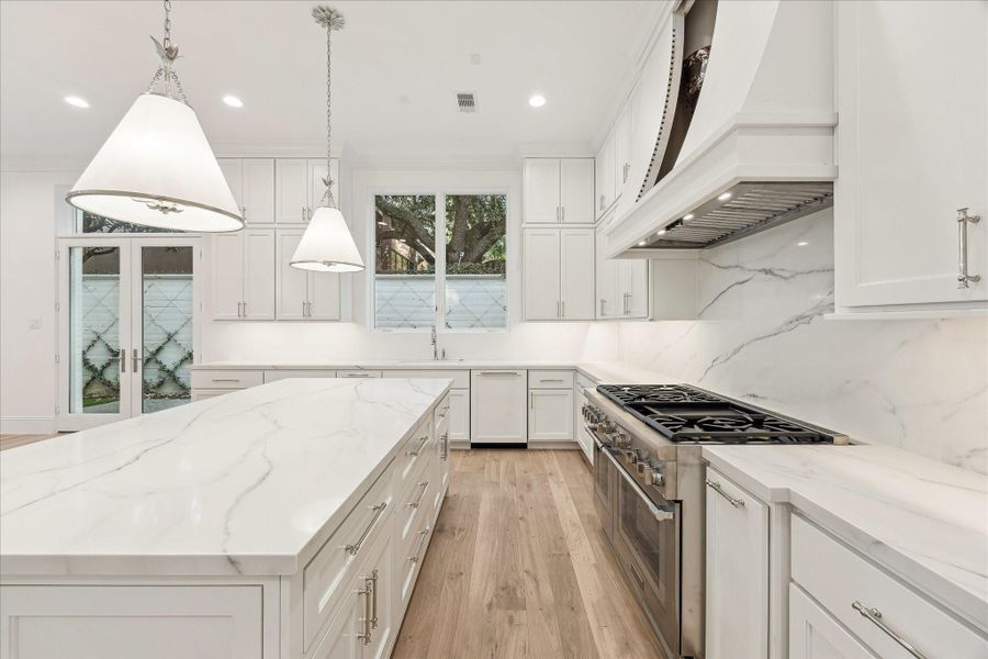 Kitchen features custom Benedettini cabinetry throughout.