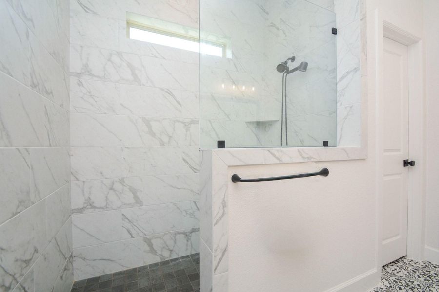 Designed for comfort and indulgence, the oversized walk-in shower features a soothing rainfall showerhead and multiple spray options, allowing you to customize every shower. Modern finishes and generous proportions create a private retreat you'll look forward to every day.