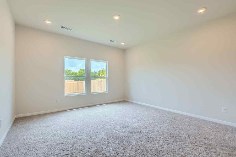 A room with a window and a carpet.