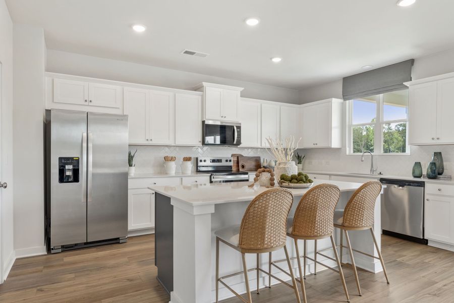 A kitchen with white cabinets. A kitchen with white cabinets.