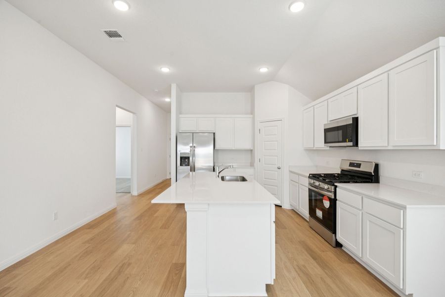 Kitchen in the Redbud home plan by Trophy Signature Homes - REPRESENTATIVE PHOTO