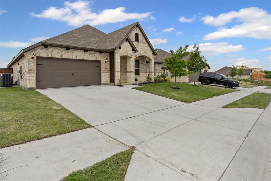 Front exterior of a new home in , Godley, TX, highlighting curb appeal (Image 23).
