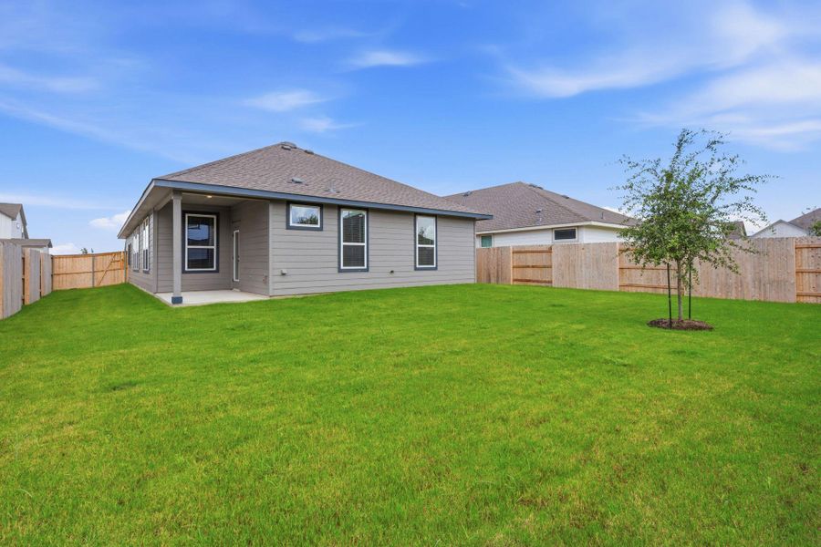A spacious, newly sodded backyard offers privacy and room for outdoor enjoyment.